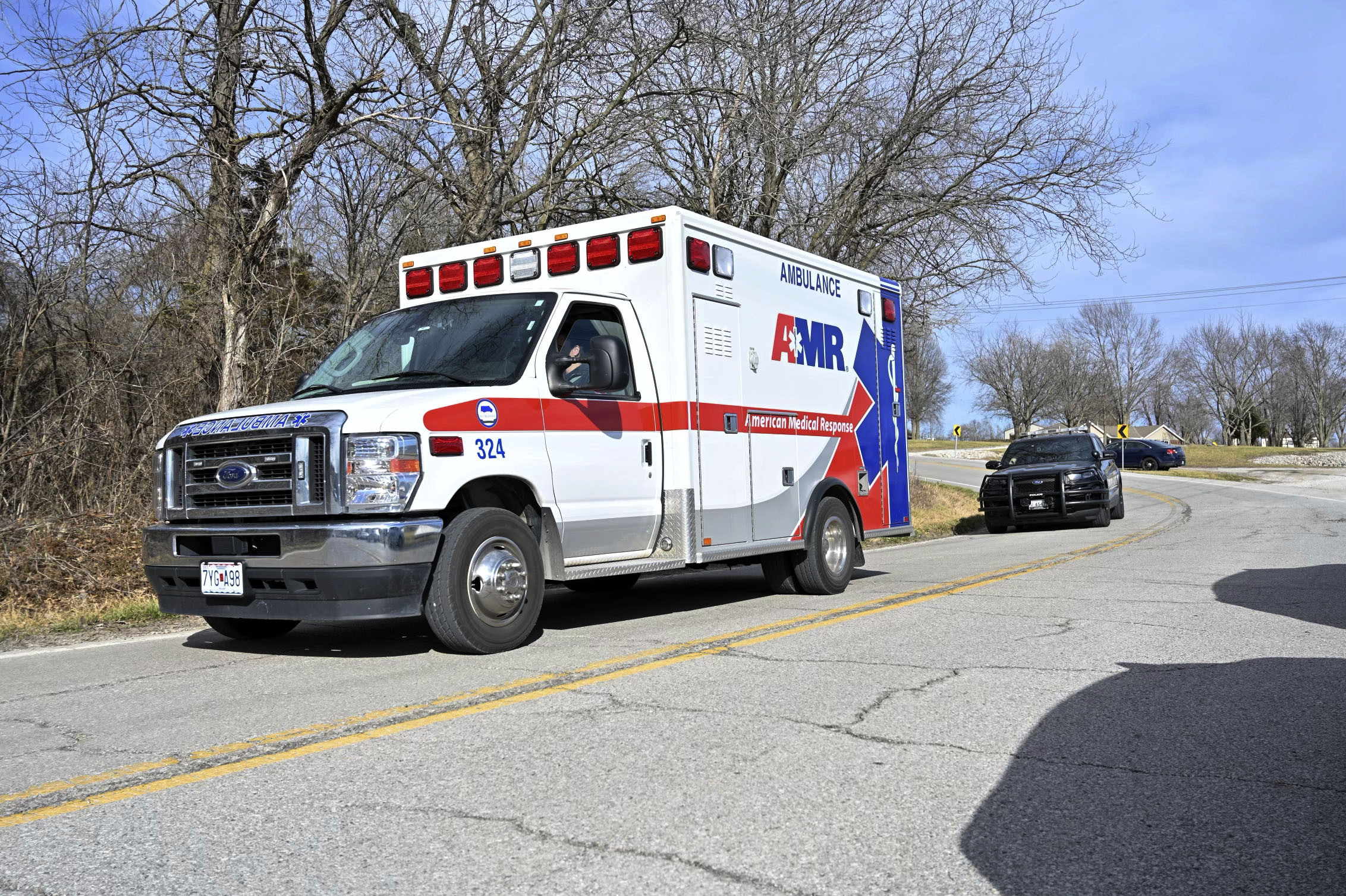 An ambulance and a police car leave the scene near Missouri 7 Highway and Bundschu Road in Independence, Mo., Thursday, Feb. 29, 2024, after multiple police officers were reported shot in the area. Authorities say two police officers were shot and wounded Thursday in Independence, Missouri. Independence Police Department spokesperson Officer Jack Taylor says the two officers were taken to a hospital. (Emily Curiel/The Kansas City Star via AP)